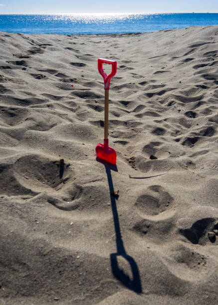 Small toy shovel on the beach in Benalmádena, Spain