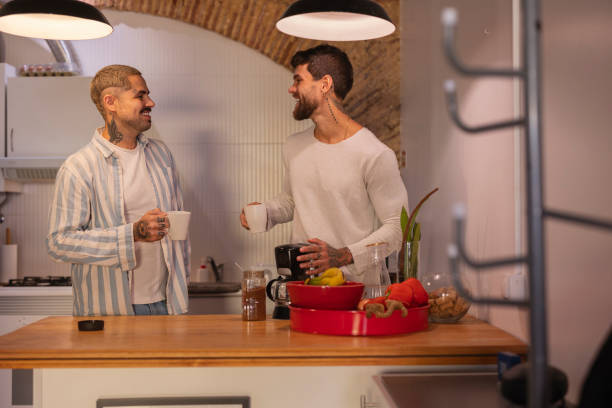 istock Gay couple enjoying coffee together in modern kitchen 2181782708