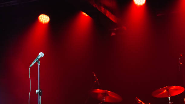 Rock Band Delivers a Captivating Concert with Lead Singer Passionately Performing on Stage with Falling Confetti, Surrounded by Band Members, Creating an Intense and Immersive Musical Atmosphere