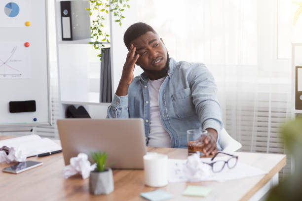 istock Stressed african american employee drinking alcohol in office 2181784136