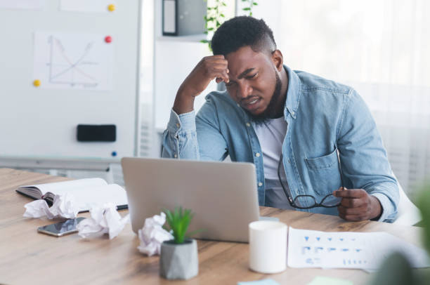 istock Stressed african worker looking to laptop screen with despair 2181784232