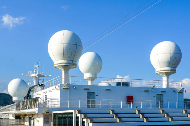 La Spezia, Italy- May 28, 2024: White satellite communication equipment domes on cruise ship MSC Seaview deck against a blue sky, radar dome
