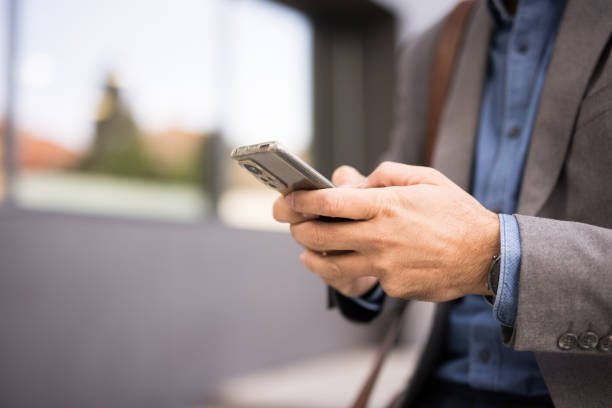 istock Close up of a businessman's hand using a smartphone 2181792386