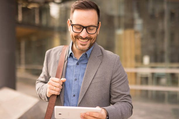 istock businessman working on a digital tablet outdoors 2181792764
