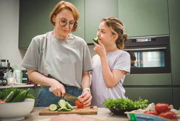 istock Mom and daughter cooks in the kitchen 2181793018