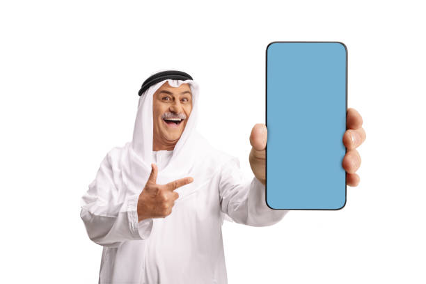 istock Traditional mature arab pointing at a blue smartphone screen 2181793045