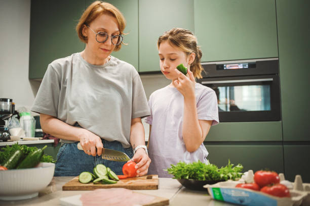 istock mother and daughter cooking in the kitchen 2181793906
