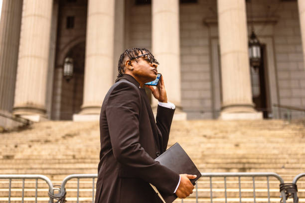 istock Business Professional on Phone Outside Courthouse 2181796785