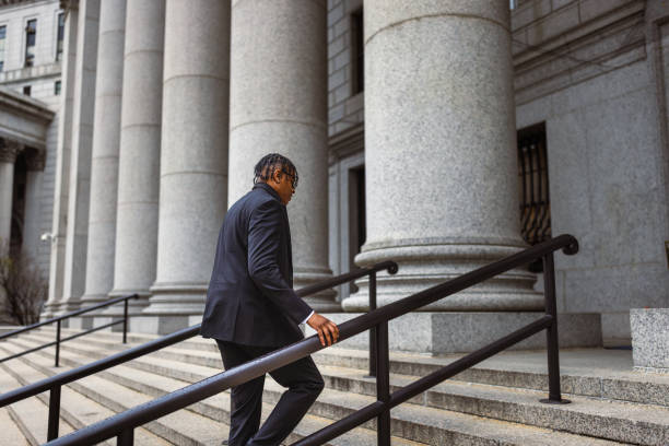 istock Business Professional Walking Up Steps to Courthouse 2181796801