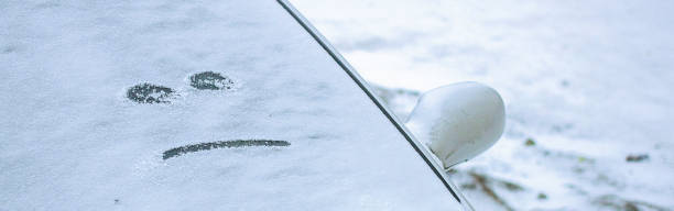 istock disgruntled smiley drawn on car windshield on cloudy winter day at sunset 2181797523