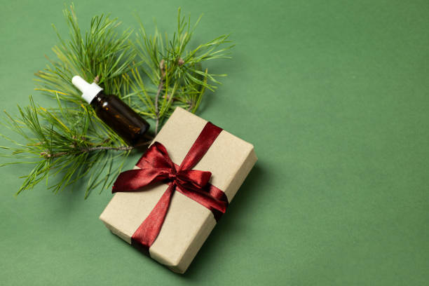 istock serum bottle with gift box with burgundy bow and pine branch 2181798083