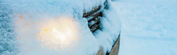 glowing head light car headlights through a layer of snow fell from the sky