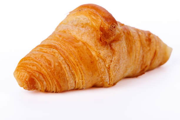 istock Artistic view of a croissant on a white infinite background, highlighting its crispy outer shell and soft interior, ideal for culinary showcases 2181799786