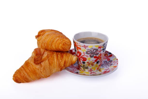istock Fresh croissants and a steaming cup of coffee placed on a light marble table, capturing a cozy and inviting breakfast moment in perfect detail 2181799970