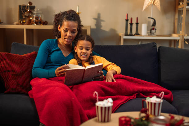 istock Mother reading a book to her daughter 2181801182