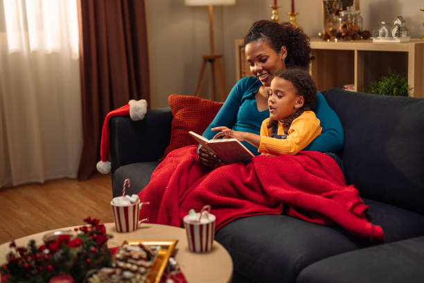 Mother reading a book to her daughter