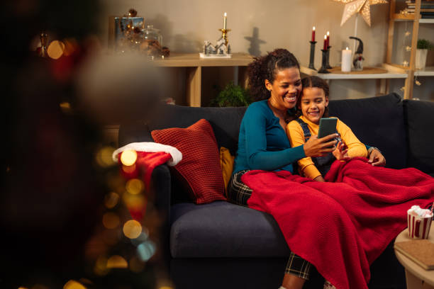 istock Cozy mother daughter time on sofa while on a video call 2181801198