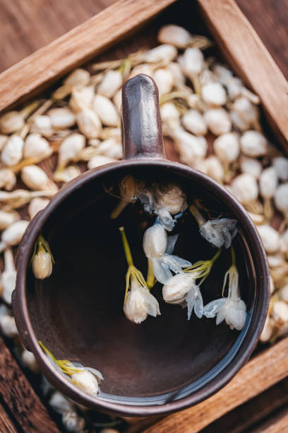 Dried jasmine tea in wooden box macrophotography