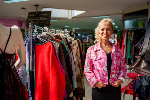 istock A woman browses through clothing racks filled with second-hand and vintage garments in a store 2181807607