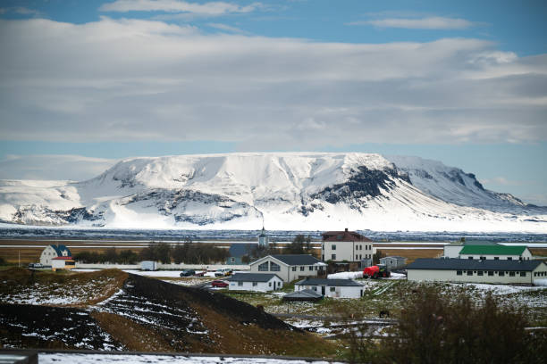 istock Snow-covered mountain with rural village and cloudy sky 2181807669