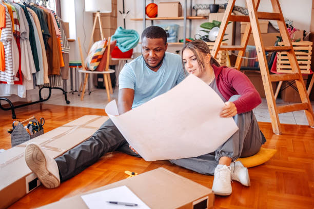 istock Young couple assembling shelf in their new home 2181809191