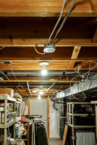 Bright new LED lightbulbs have been installed in this basement storage room ceiling electric light sockets for a big improvement in lighting.