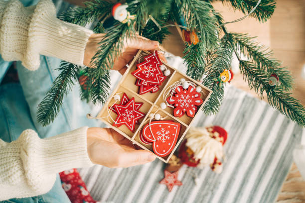 istock Box of diverse ornaments cradled beneath the tree. 2181811276