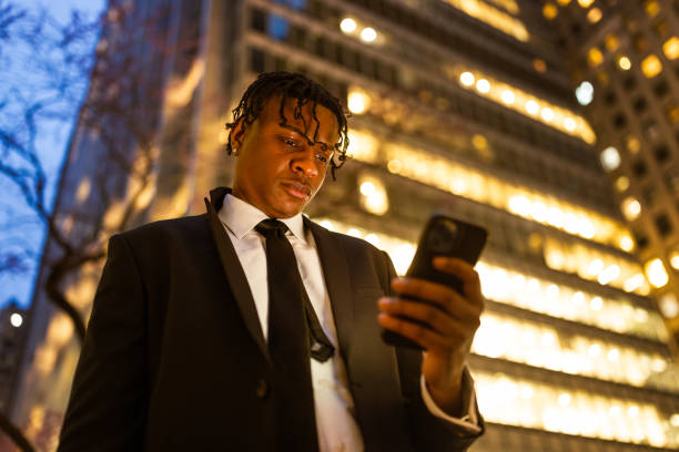 istock Formal Businessman in Urban Environment Using Smartphone 2181811378