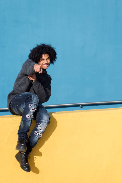 istock teenager smiling happy pointing looking at camera 2181814740