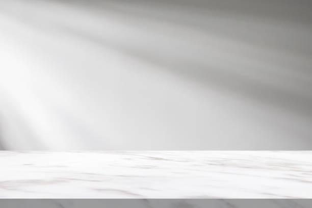 istock Marble table with window shadow drop on white wall background for mockup product display 2181815114
