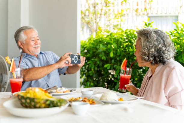 istock Asian senior couple having lunch at restaurant. 2181817655