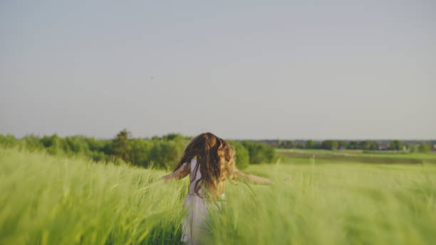 istock Joyful Girl Running in Wheat Field 2181817699