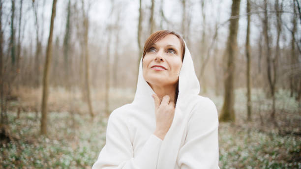 istock Serene Mature Woman in Snowdrop-Filled Forest 2181817745