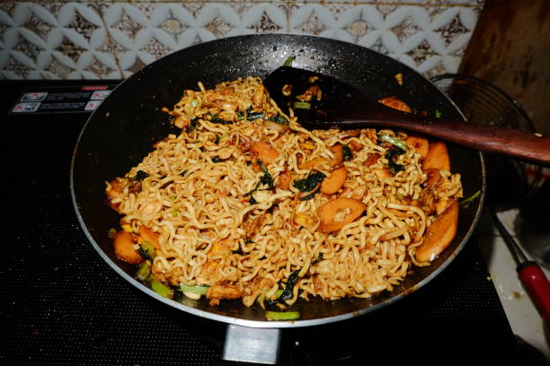 istock Fried noodles with sausage in a frying pan 2181824584