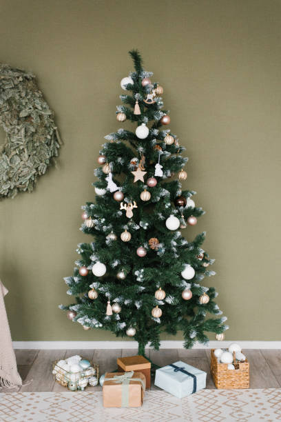 istock Large Christmas tree with many ornaments on it is surrounded by boxes and a wreath 2181827956