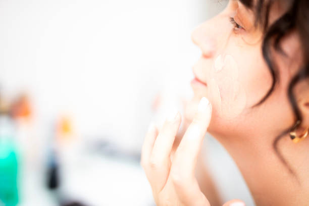 istock Woman applying makeup in front of mirror 2181827961