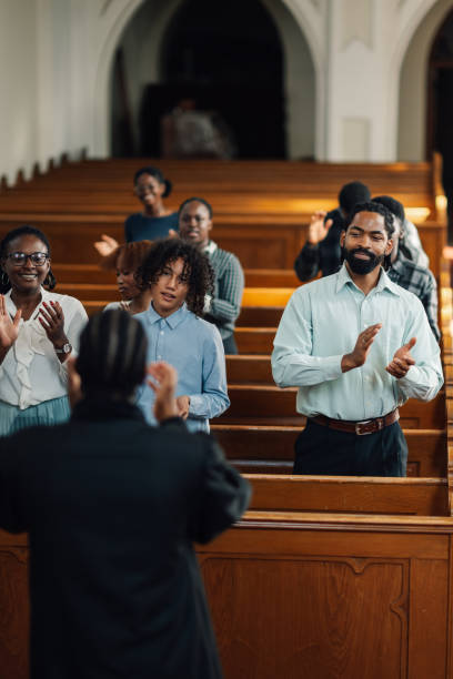 istock Congregation clapping along to gospel music in church 2181828299