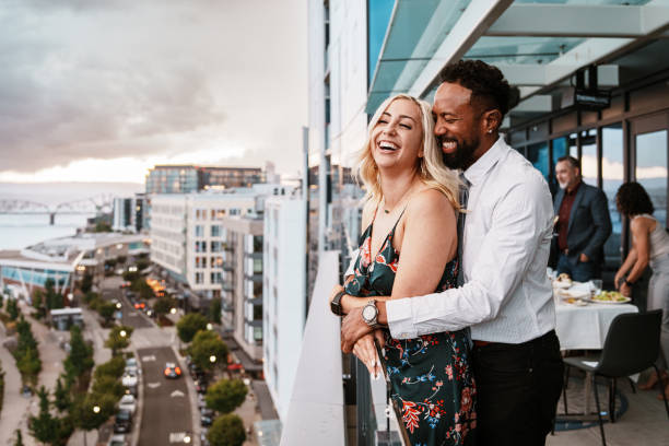 Loving couple enjoying sunset views from restaurant rooftop terrace