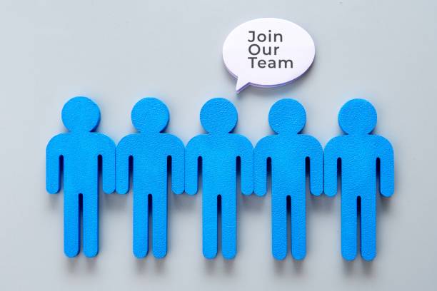 istock A row of blue figures with a speech bubble saying Join Our Team. 2181833625