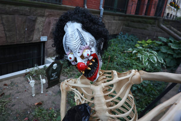 A skeleton wears a mask of a killer clown in the front of a Yorkville townhouse in New York, N.Y., Wednesday, Oct. 23, 2024. (Photo: Gordon Donovan)
