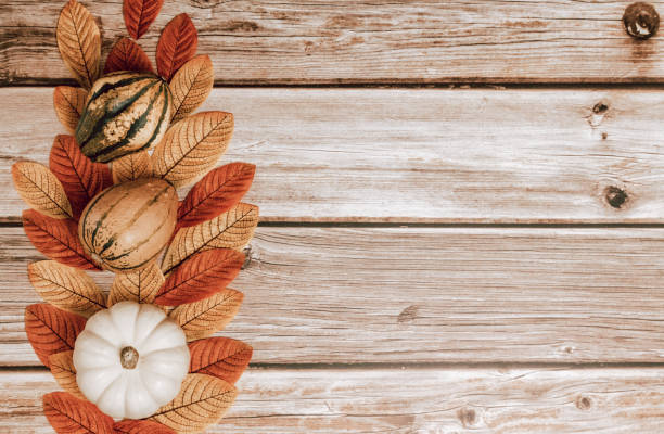 istock Three squashes and leaves on a wooden table. 2181838788
