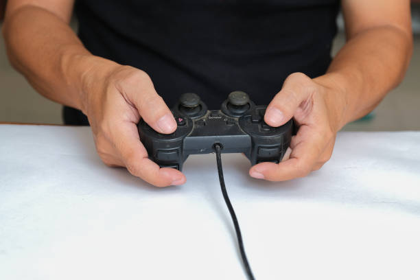 istock Close-up photo of hands holding black computer game joypad 2181840840