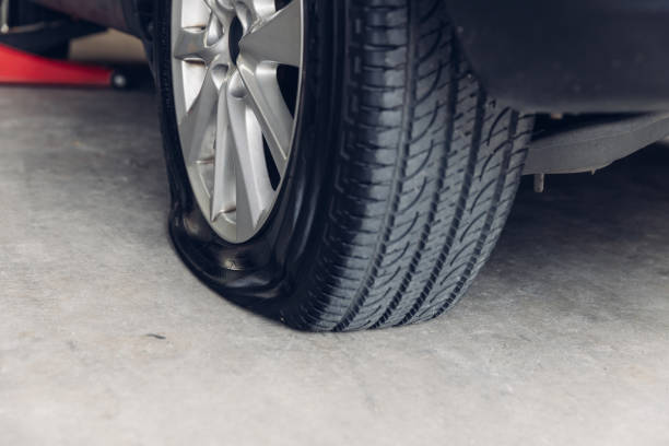 istock Destroyed blown out tire with exploded, shredded and damaged tire on a modern automobile. damaged truck rubber after tire explosion at high speed. Damaged flat tires: old car. 2181844210