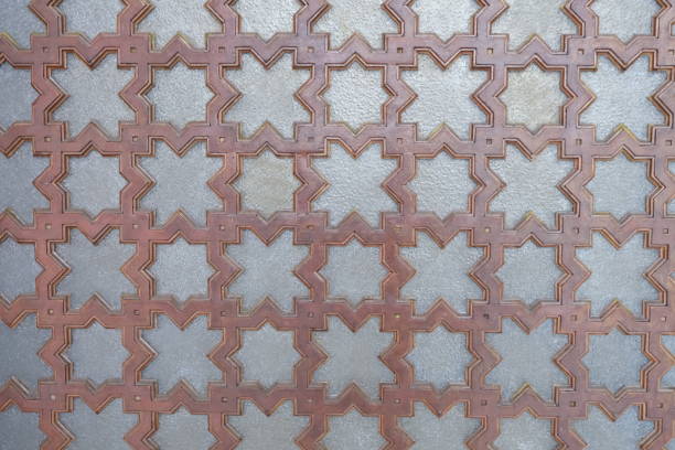Geometric star-patterned tile design with interlocking shapes in earthy tones, creating a textured effect.