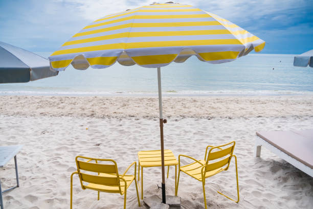 istock Yellow Umbrella by the Sea 2181846080