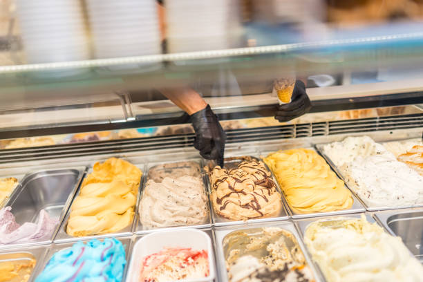 istock Worker picking ice cream from counter of a store 2181859345