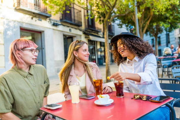 Tourist eating tapas and drinking sodas in outside bar