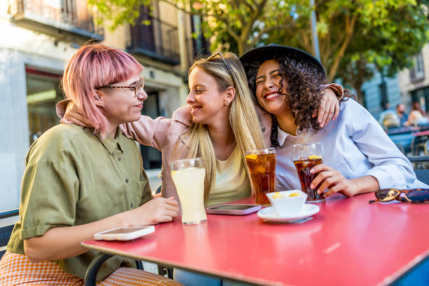 istock Happy woman embracing drinking in a sidewalk cafeteria 2181859437