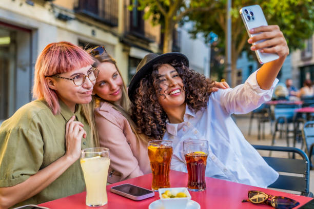 istock Happy friends taking selfie together sitting on a sidewalk cafeteria 2181859471