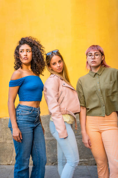 istock Three different models posing with casual clothes against yellow background 2181859551